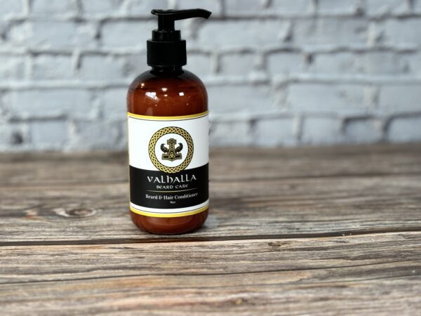 A bottle of lotion sitting on top of a wooden table.