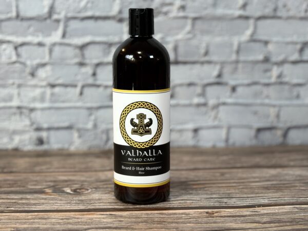 A bottle of valhalla beard oil sitting on top of a table.