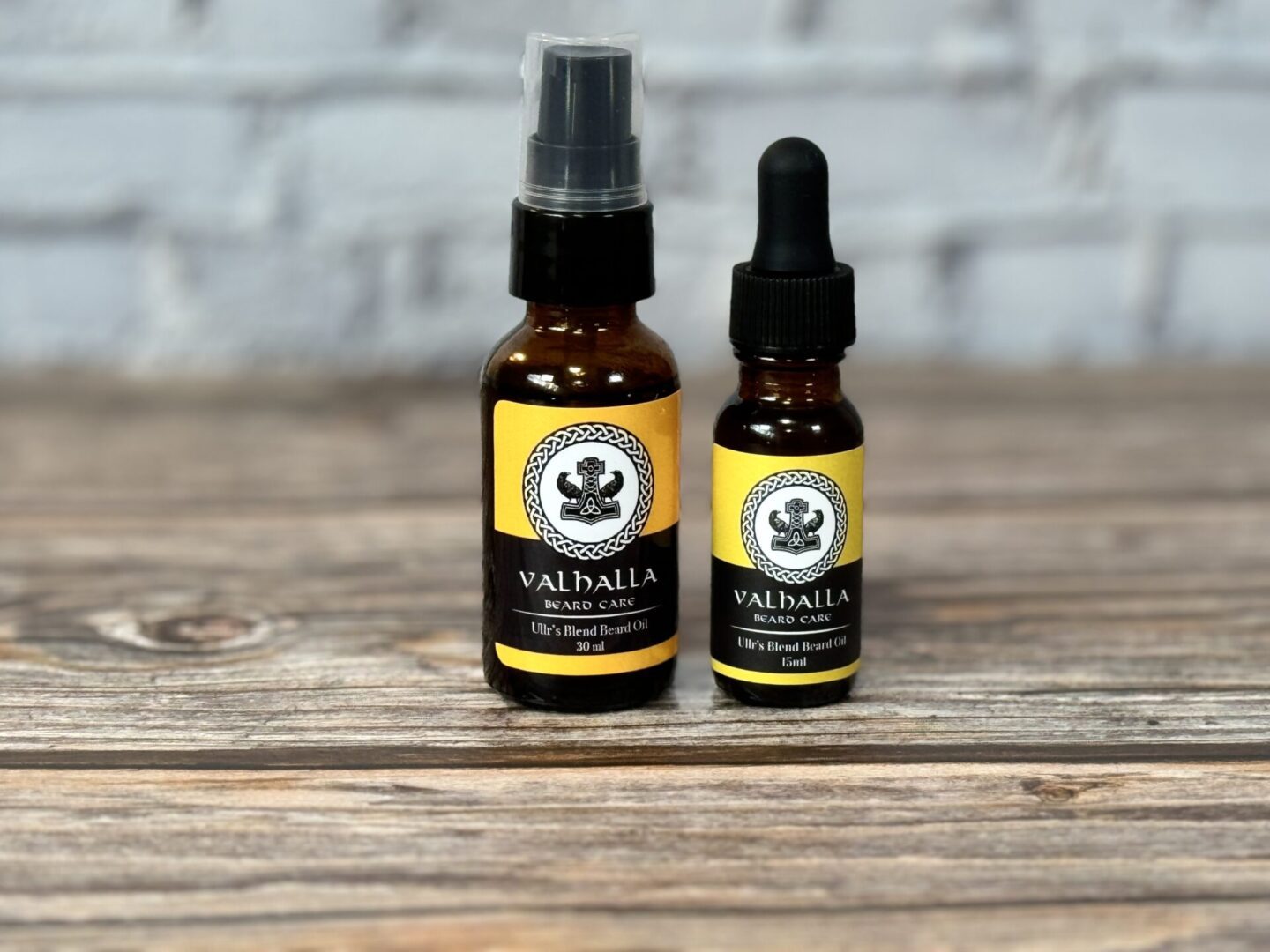 A bottle of oil and a small bottle on top of a table.