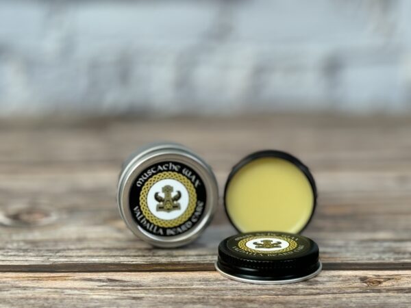A close up of two containers of lip balm