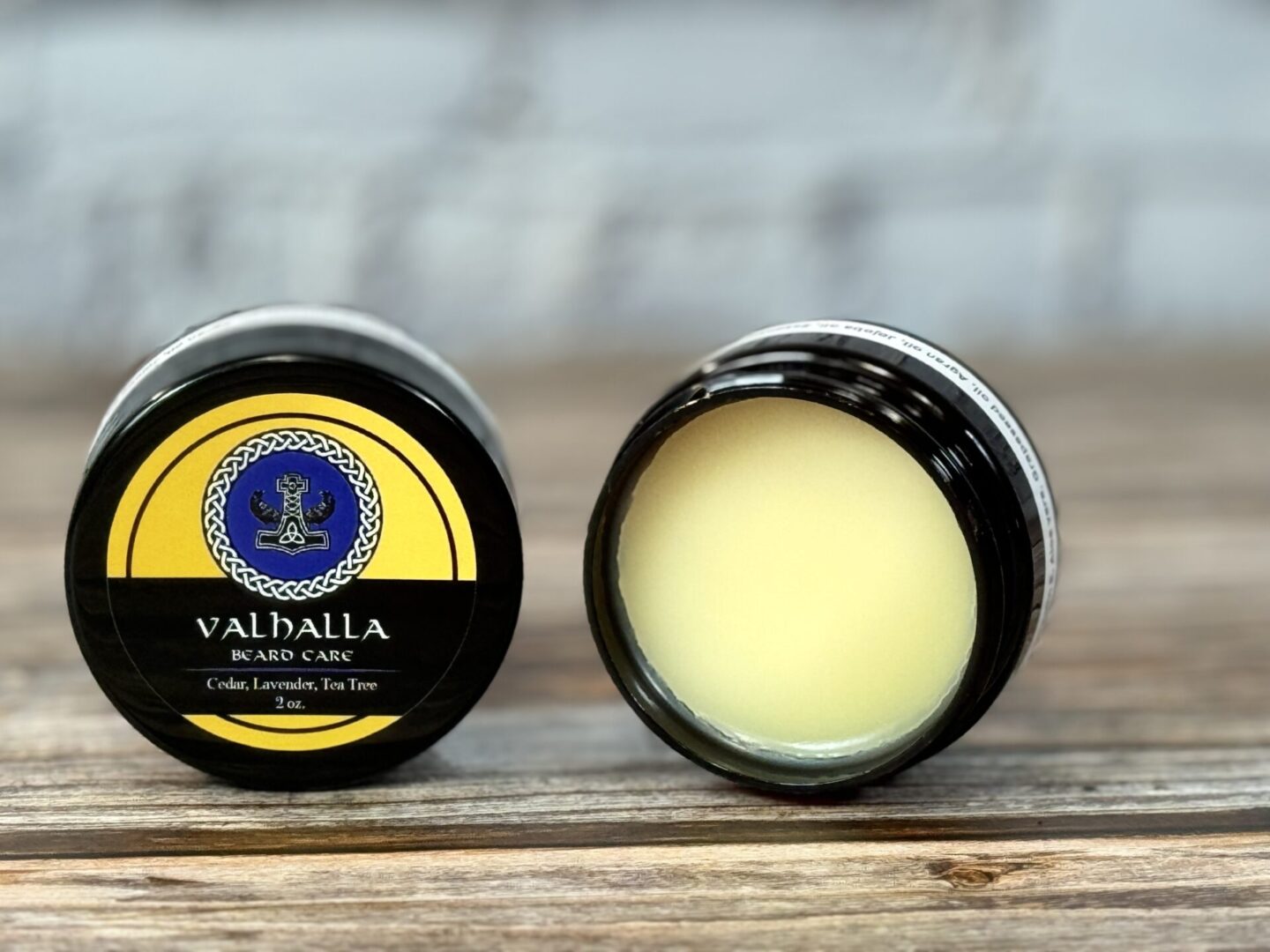 A couple of jars sitting on top of a wooden table.