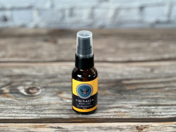 A bottle of oil sitting on top of a wooden table.