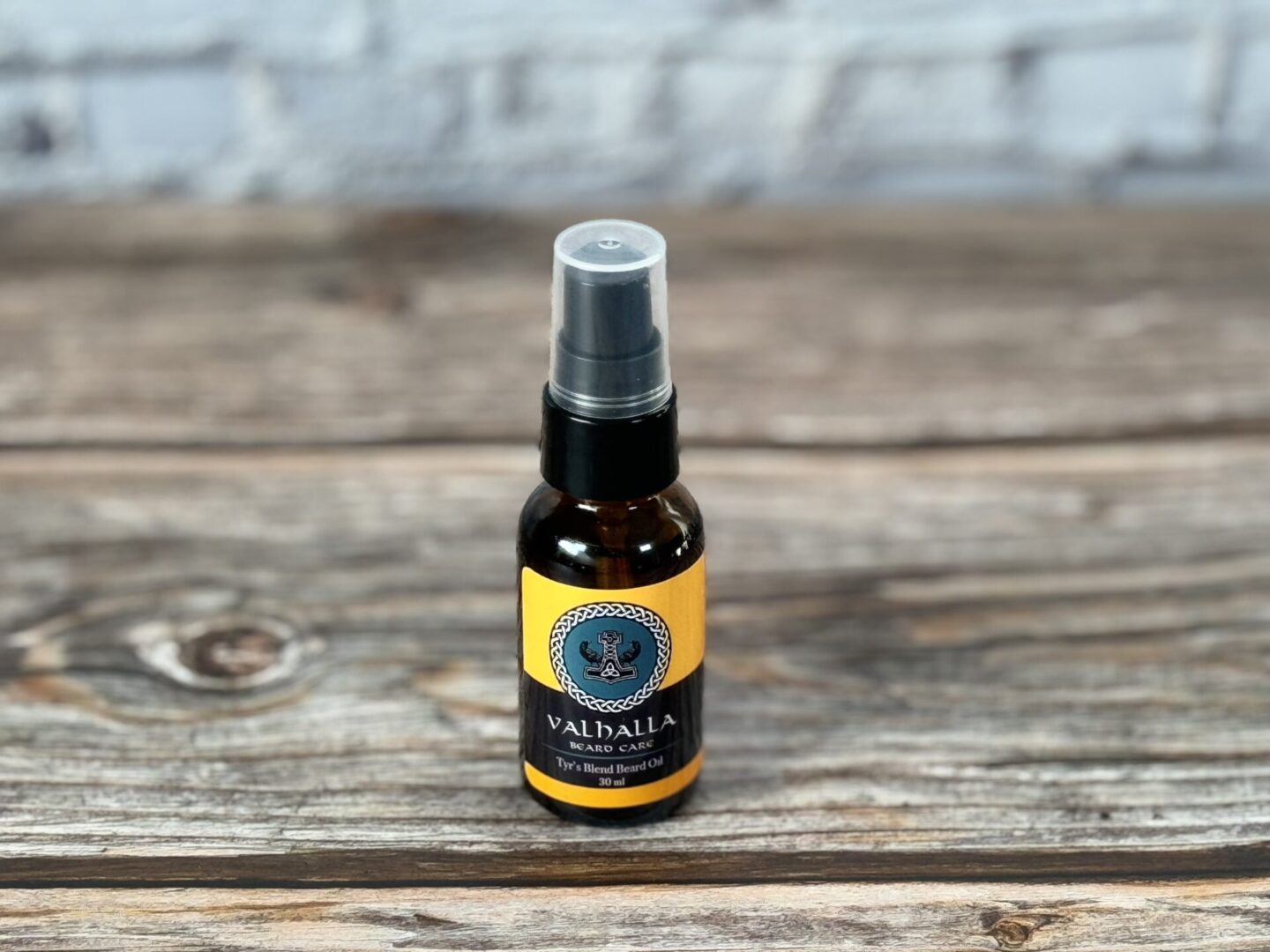A bottle of oil sitting on top of a wooden table.