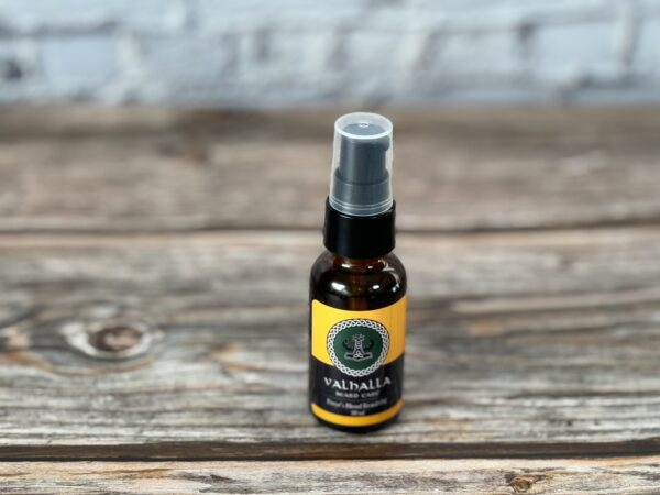 A bottle of oil sitting on top of a wooden table.