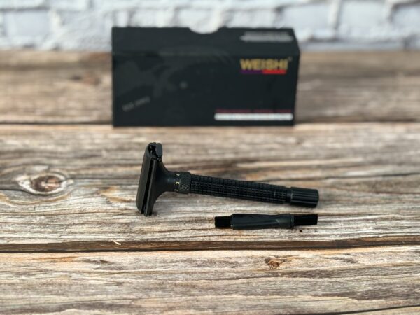 A razor is sitting on the table next to its box.