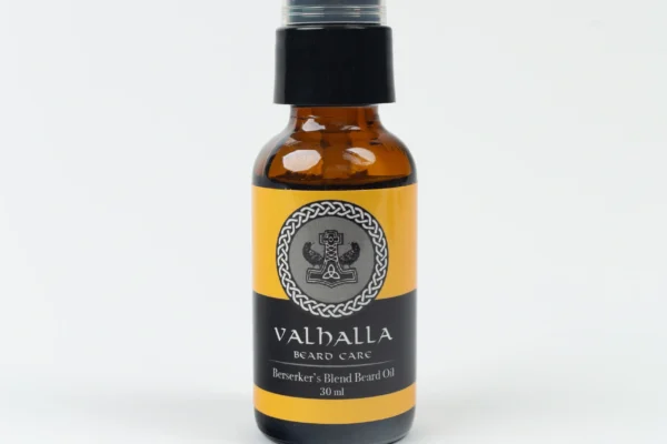 A bottle of beard oil sitting on top of a table.