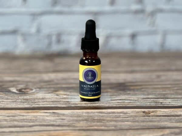 A bottle of cbd oil sitting on top of a wooden table.