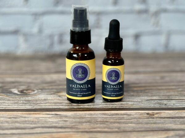 Two bottles of oil sitting on top of a wooden table.