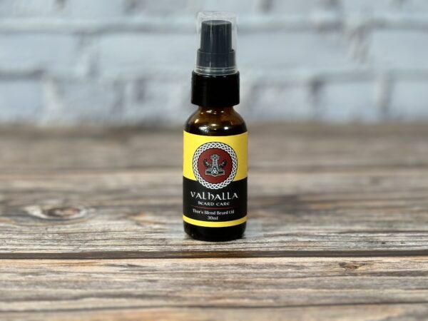 A bottle of oil sitting on top of a wooden table.
