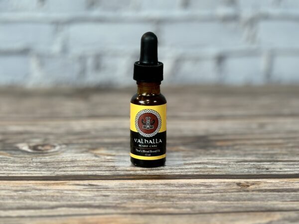 A bottle of cbd oil sitting on top of a wooden table.