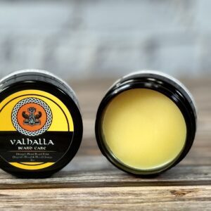 A close up of two containers of balm