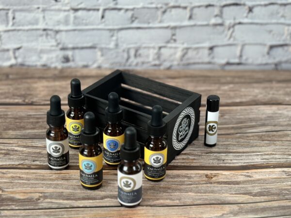 A wooden crate with bottles of oils on top.