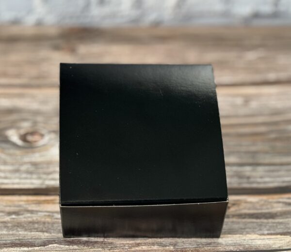 A black box sitting on top of a wooden table.